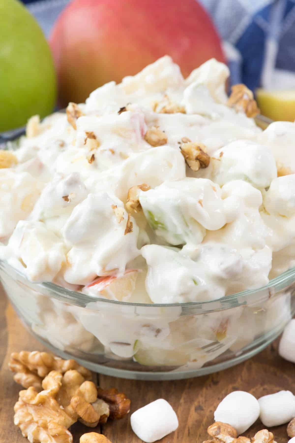 sliced apple and nuts and marshmallows mixed together in a bowl.