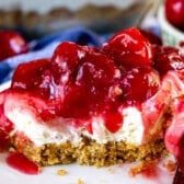 charm cracker crust topped with cherry pie filling on a plate.