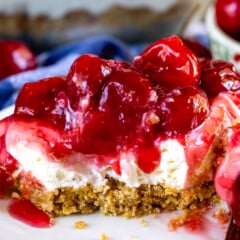 charm cracker crust topped with cherry pie filling on a plate.