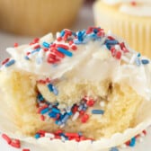 cupcakes covered in red white and blue sprinkles and white frosting.