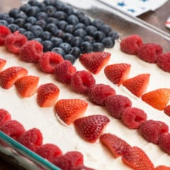 flag cake with blueberries and strawberries on top forming the American flag.