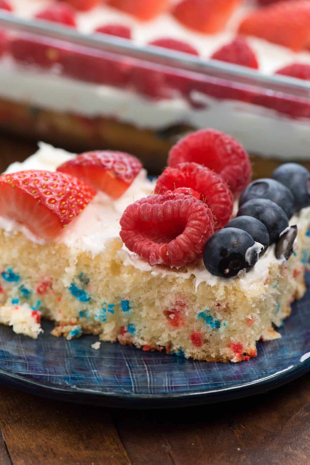 flag cake with blueberries and strawberries on top forming the American flag.