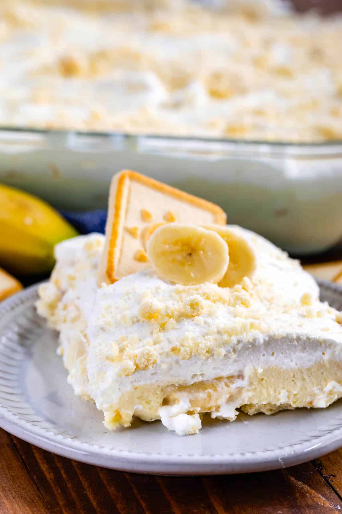 bananas and pudding stacked with crumbles and banana slices on top.