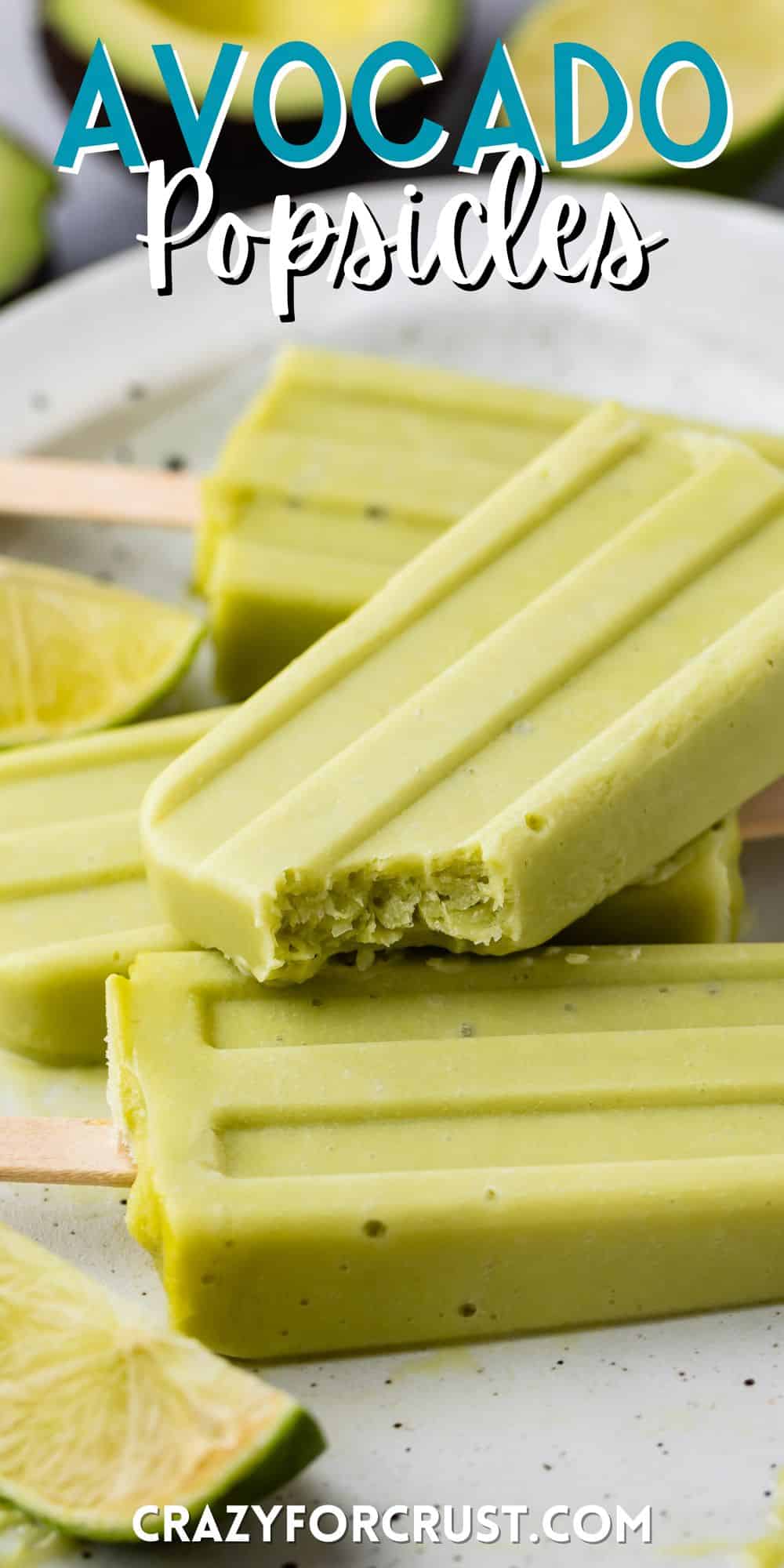 stacked green popsicles with wooden sticks at the bottoms on a white plate with words on the image.