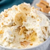 banana fluff in a white bowl with banana slices on top.