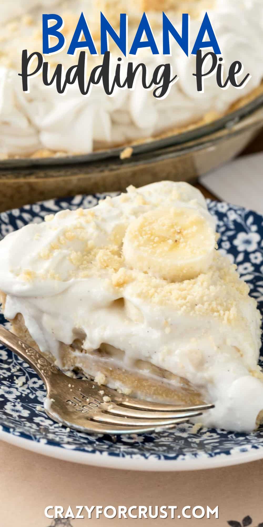 pie topped with a banana slice on a blue and white plate next to a fork with words on the image.