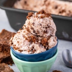 scoops of brown brownie batter ice cream in two stacked bowls.