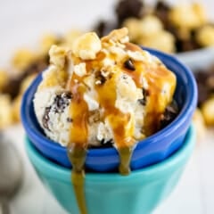 stacked blue bowls with ice cream in the bowls topped with caramel.