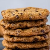 large stack of chocolate chip cookies with words on the image.
