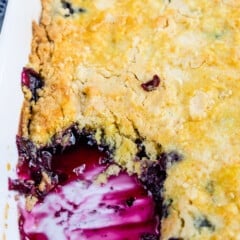 cobbler with a scoop taken out of it in a white glassware.