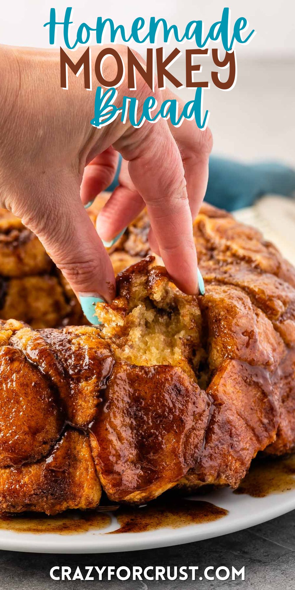 monkey bread on a white plate with a hand holding a piece of it with words on the image.