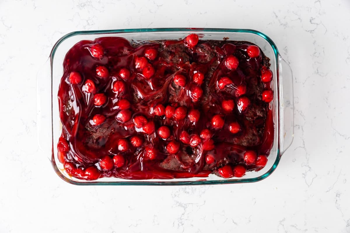 process shot of cherry coke poke cake.