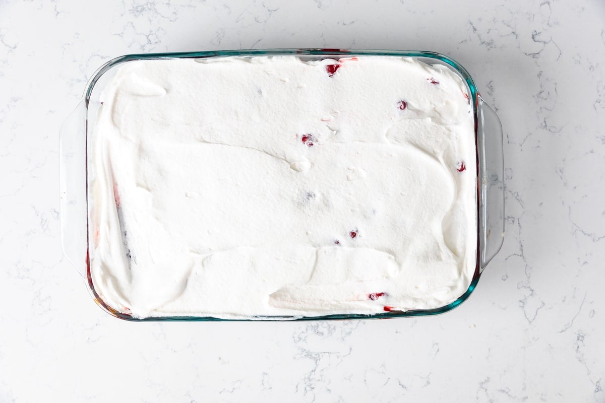 process shot of cherry coke poke cake.