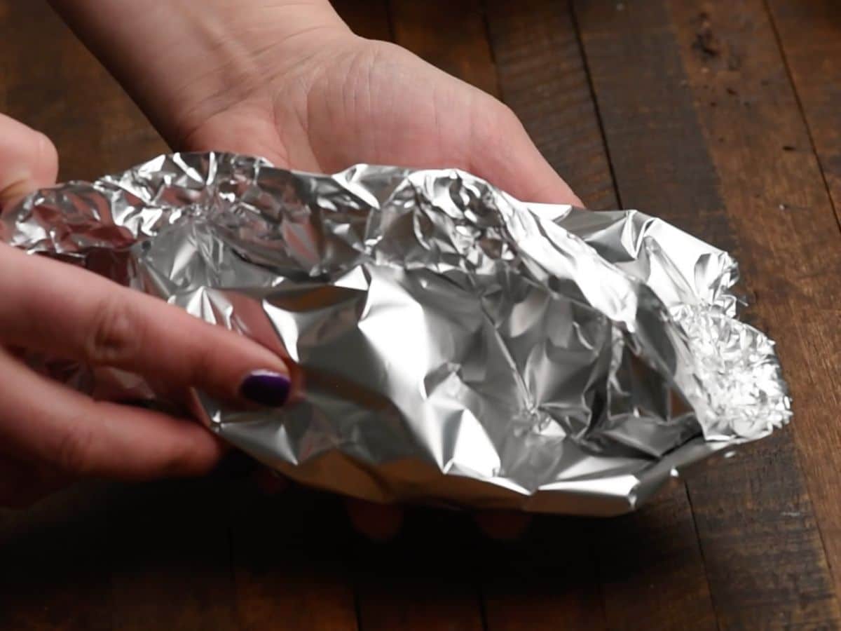 hands holding foil packet