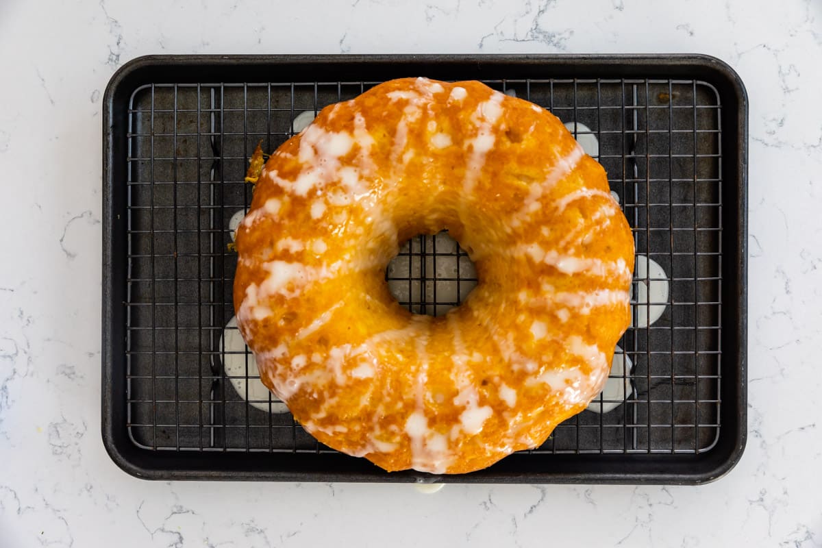 cake on rack over cookie sheet with drizzle.