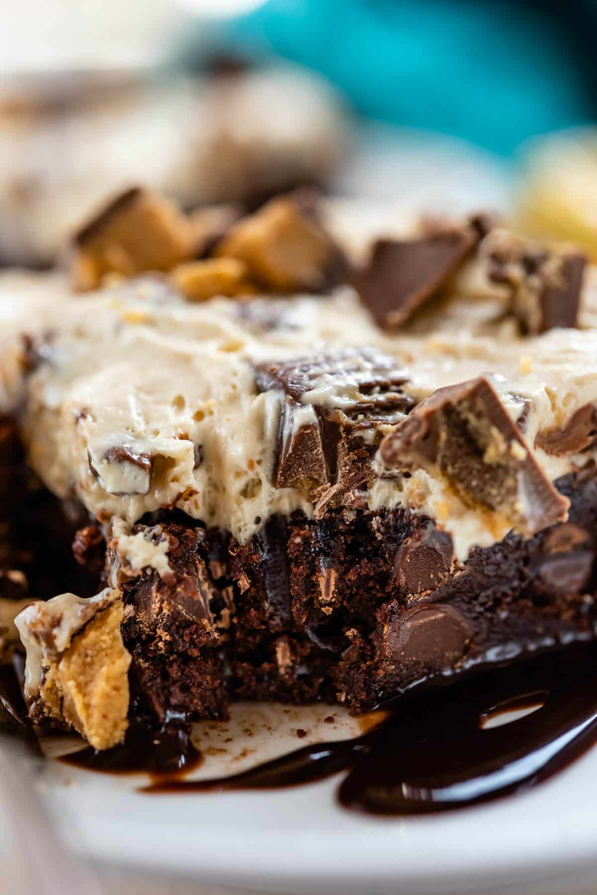 square slice of ice cream brownies on a white plate next to a fork.