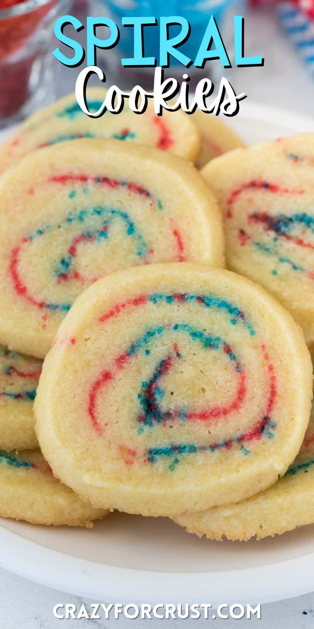 stacked cookies that are swirled with red and blue sprinkles.