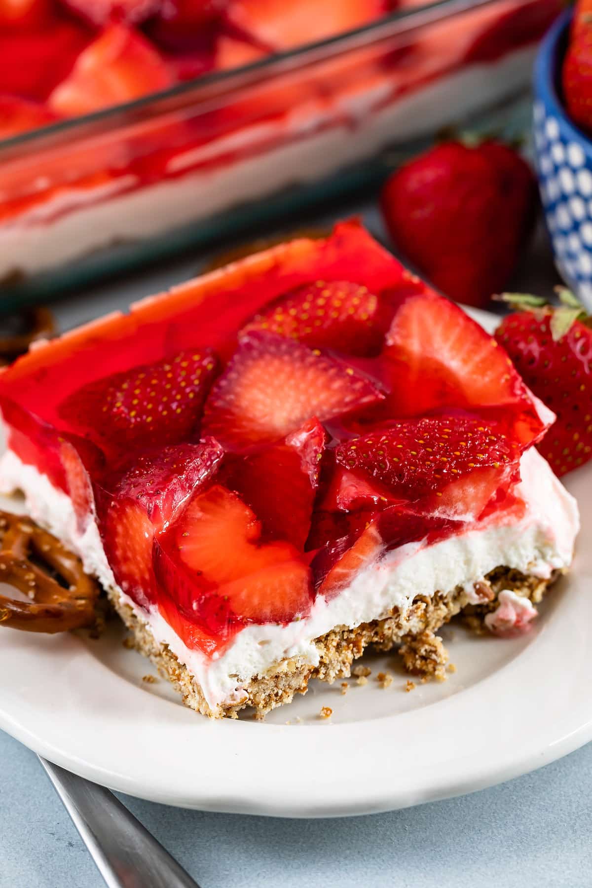 strawberries layered with crust and filling on a plate.