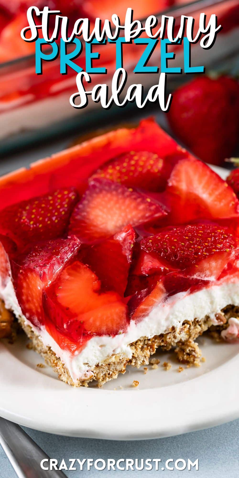 strawberries layered with crust and filling on a plate with words on the image.