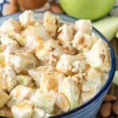 caramel apple salad in a see-through blue bowl.