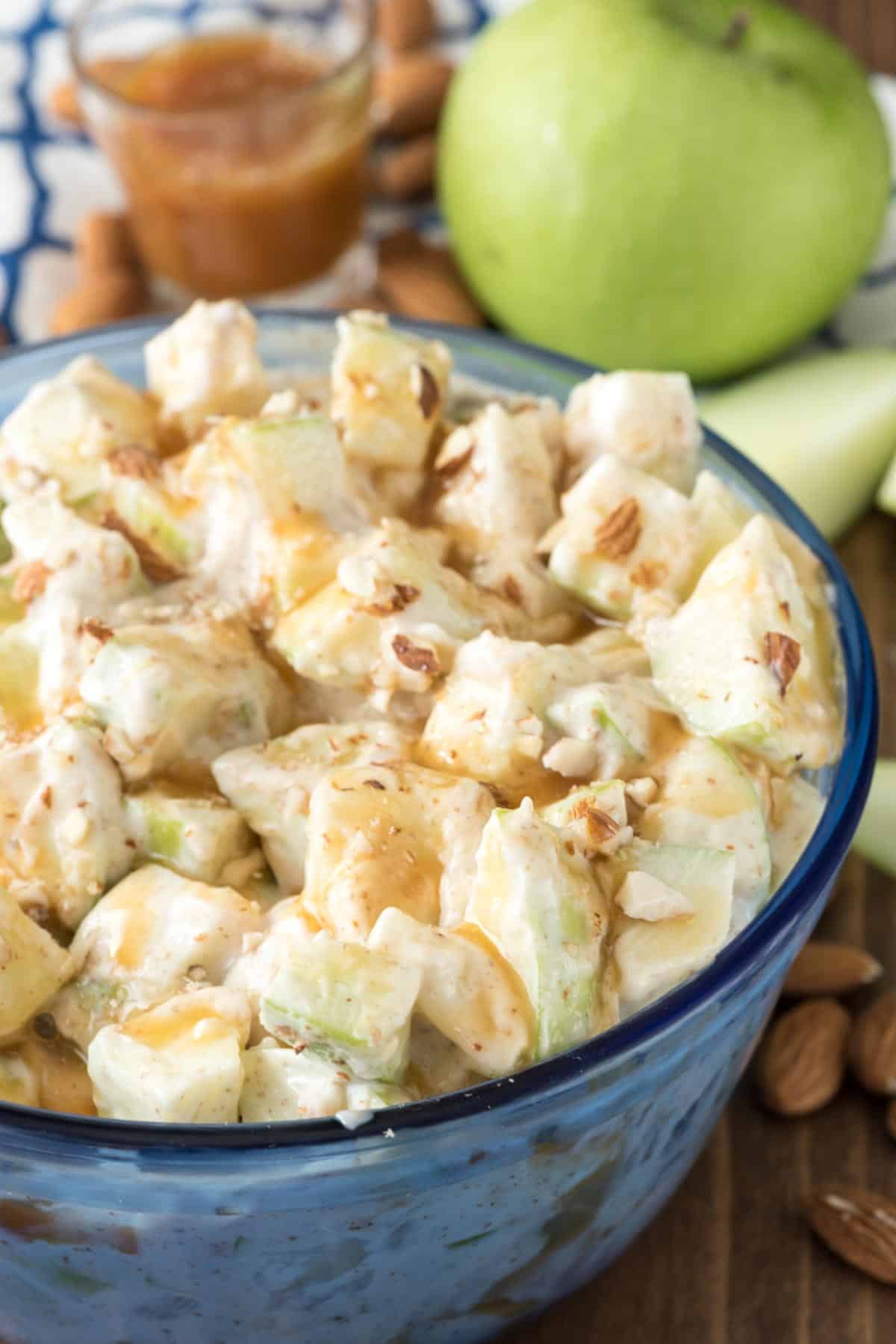 caramel apple salad in a see-through blue bowl.