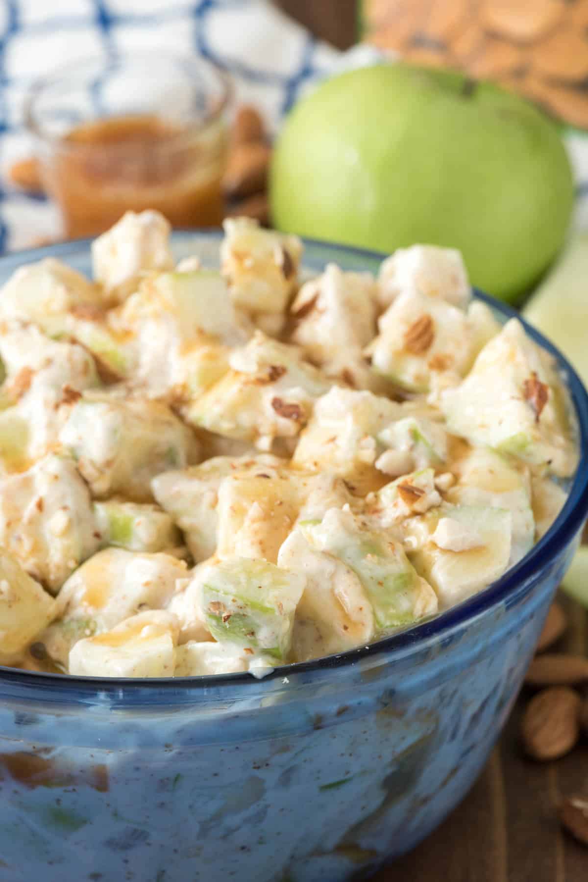 caramel apple salad in a see-through blue bowl.