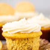 banana cupcakes next to golden oreos with white frosting.