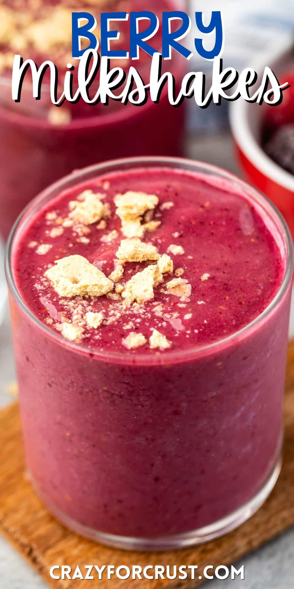 pink smoothie in a clear glass with crumbled cookies on top with words on the image.
