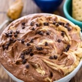 dip in a white bowl with mini chocolate chips sprinkles on top.