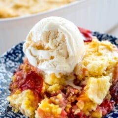 yellow and red dump cake with a scoop of vanilla on the cake.