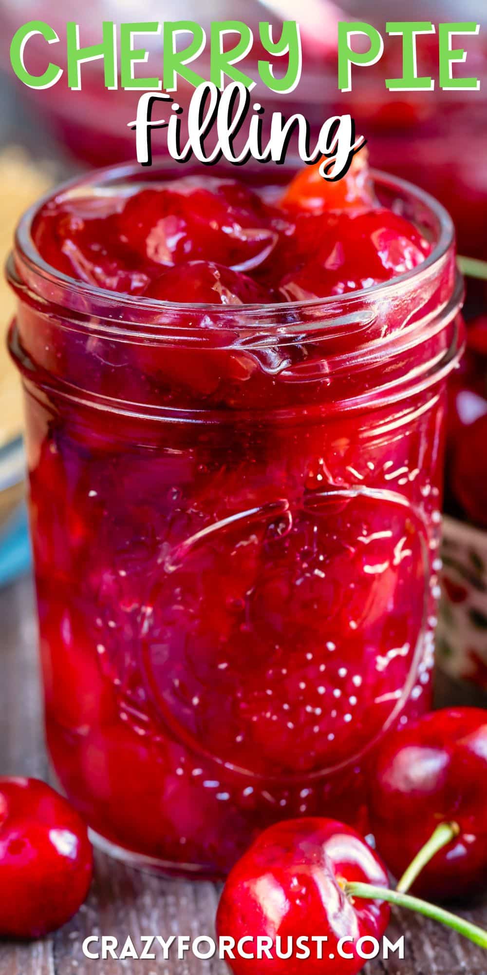 cherry pie in a clear mason jar surrounded by cherries with words on the image.