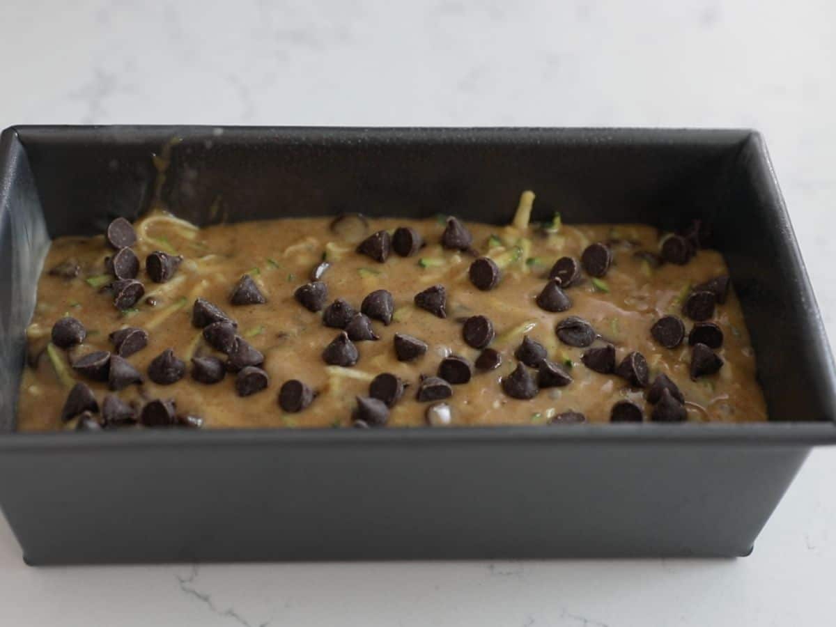 loaf pan with batter and chocolate chips on top