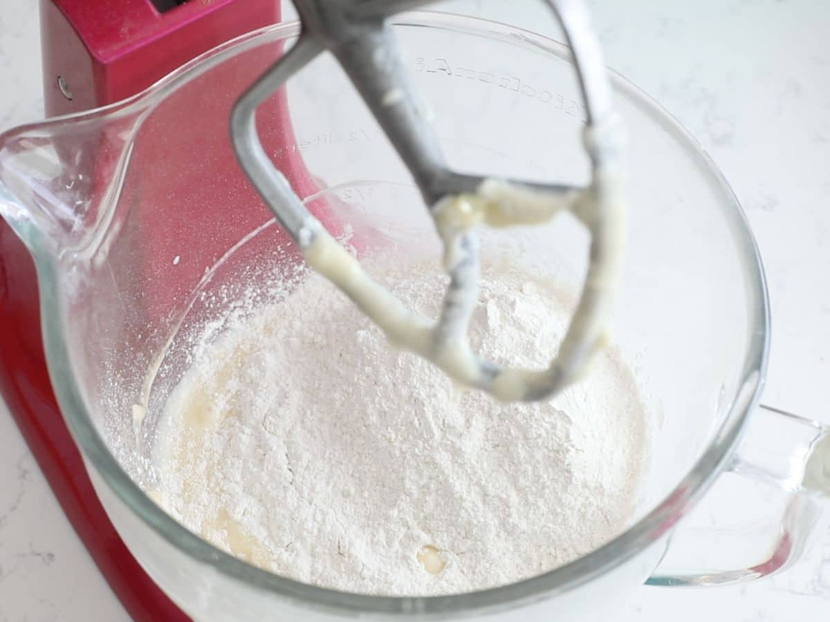 bowl in mixer with cookie dough and flour