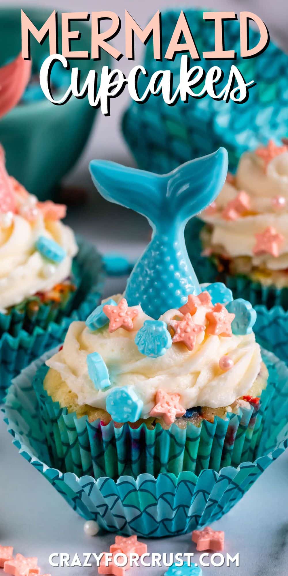 cupcakes in scaled cupcake wrappers with candy mermaid tails on top with words on the image.