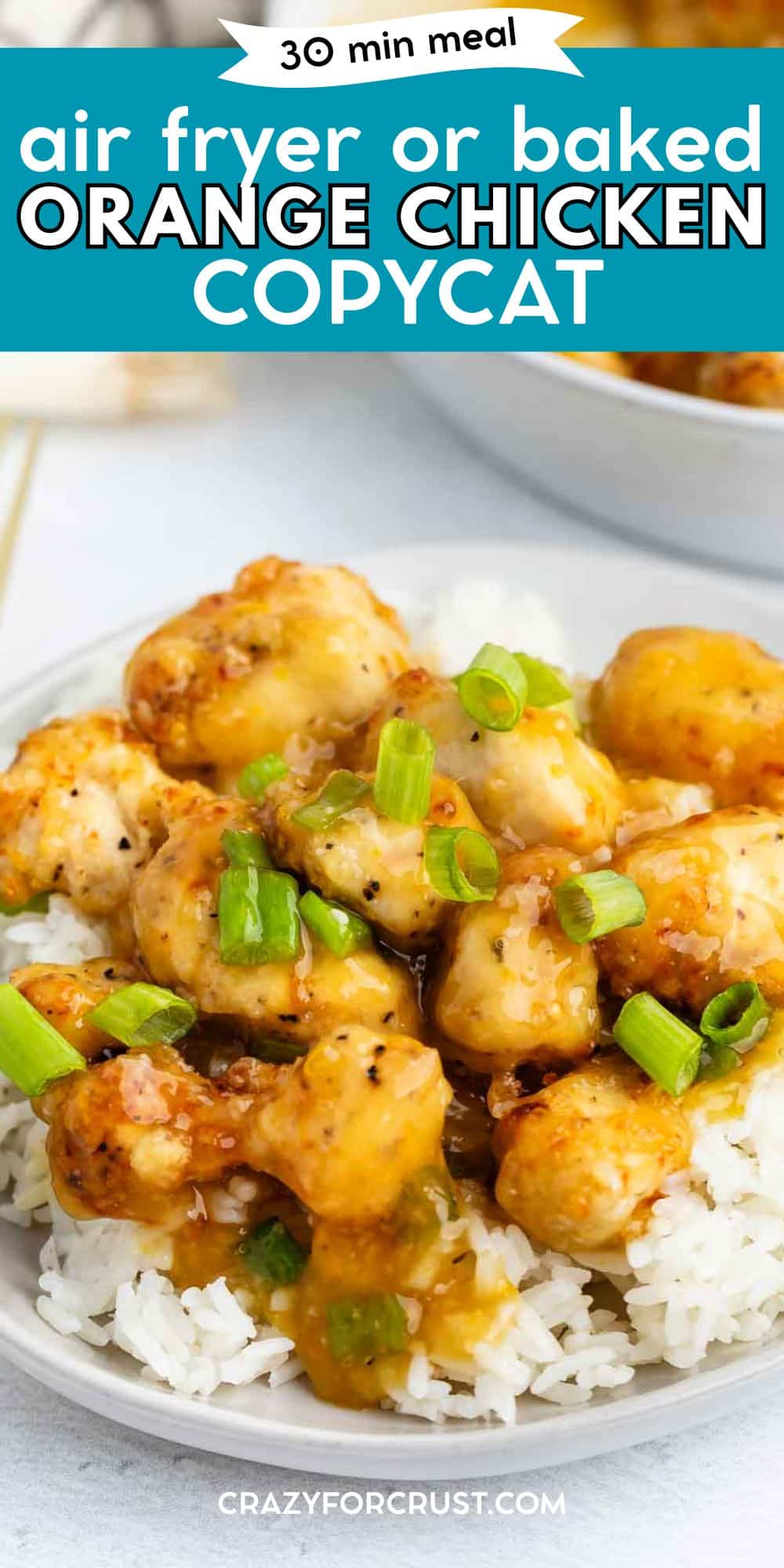 A plate of white rice topped with crispy Baked Orange Chicken pieces, garnished with chopped green onions, with text overlay reading “30 min meal, air fryer or baked orange chicken copycat.”.