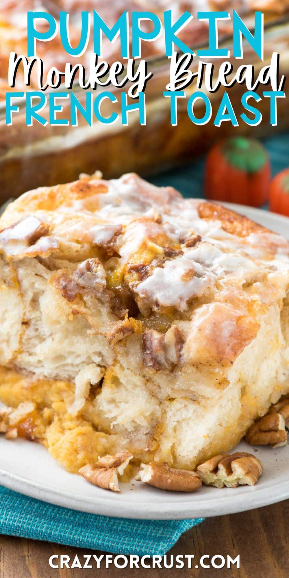 pumpkin monkey bread on a white plate with nuts sprinkled around with words on the image.