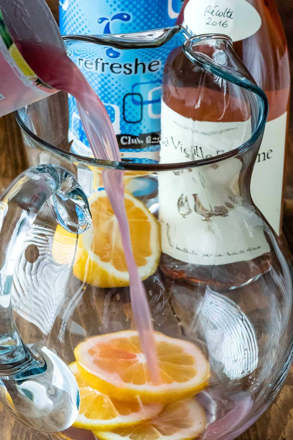 drinks being poured into the clear glass pitcher.