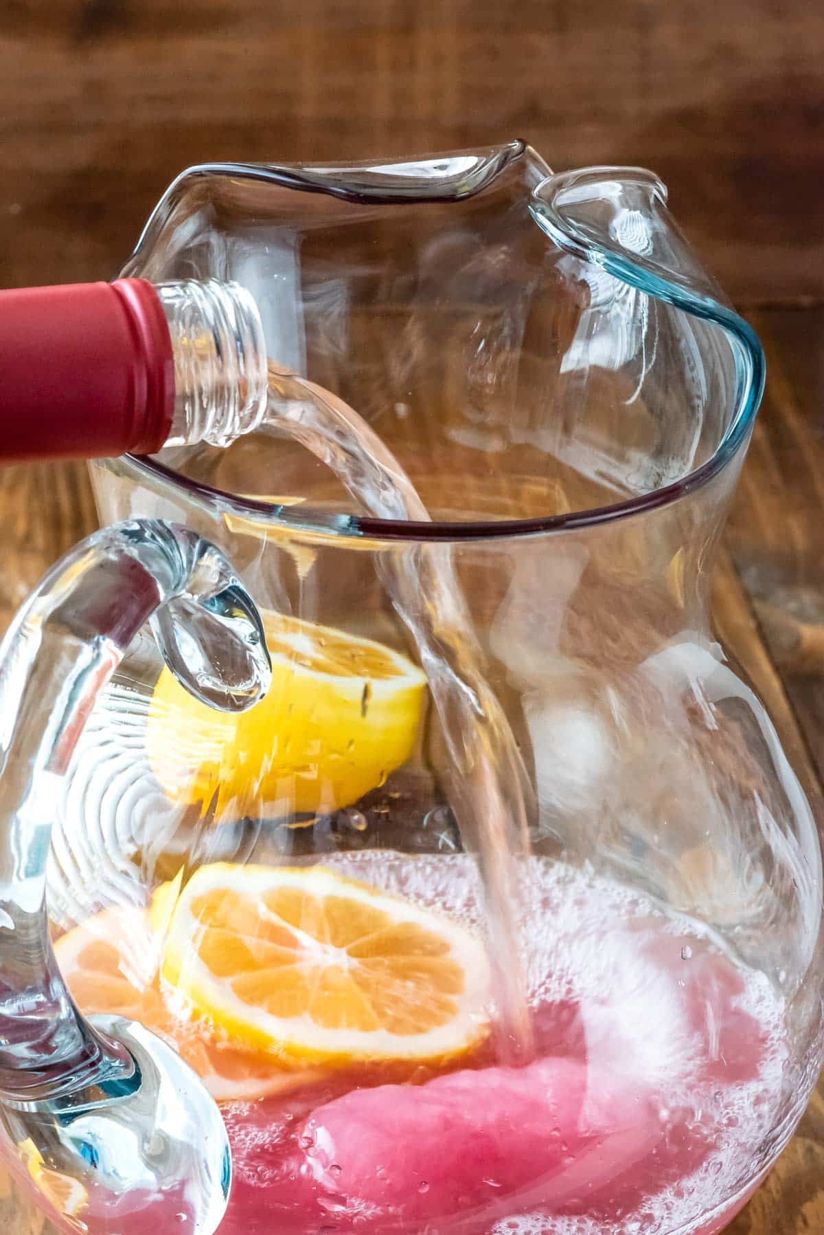 drinks being poured into the clear glass pitcher.