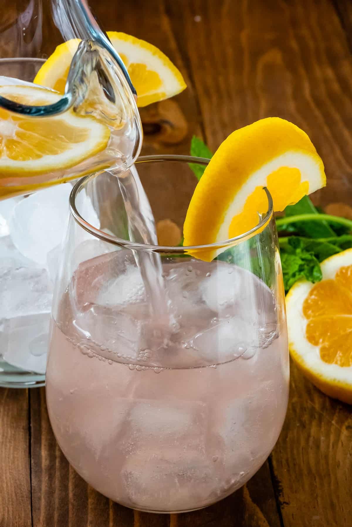 rose in clear glass with a lemon slice on the rim.