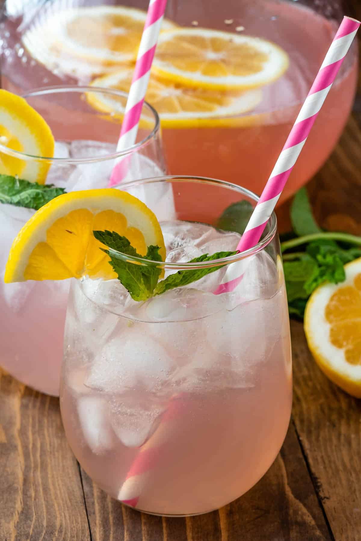 rose in clear glass with a lemon slice on the rim.