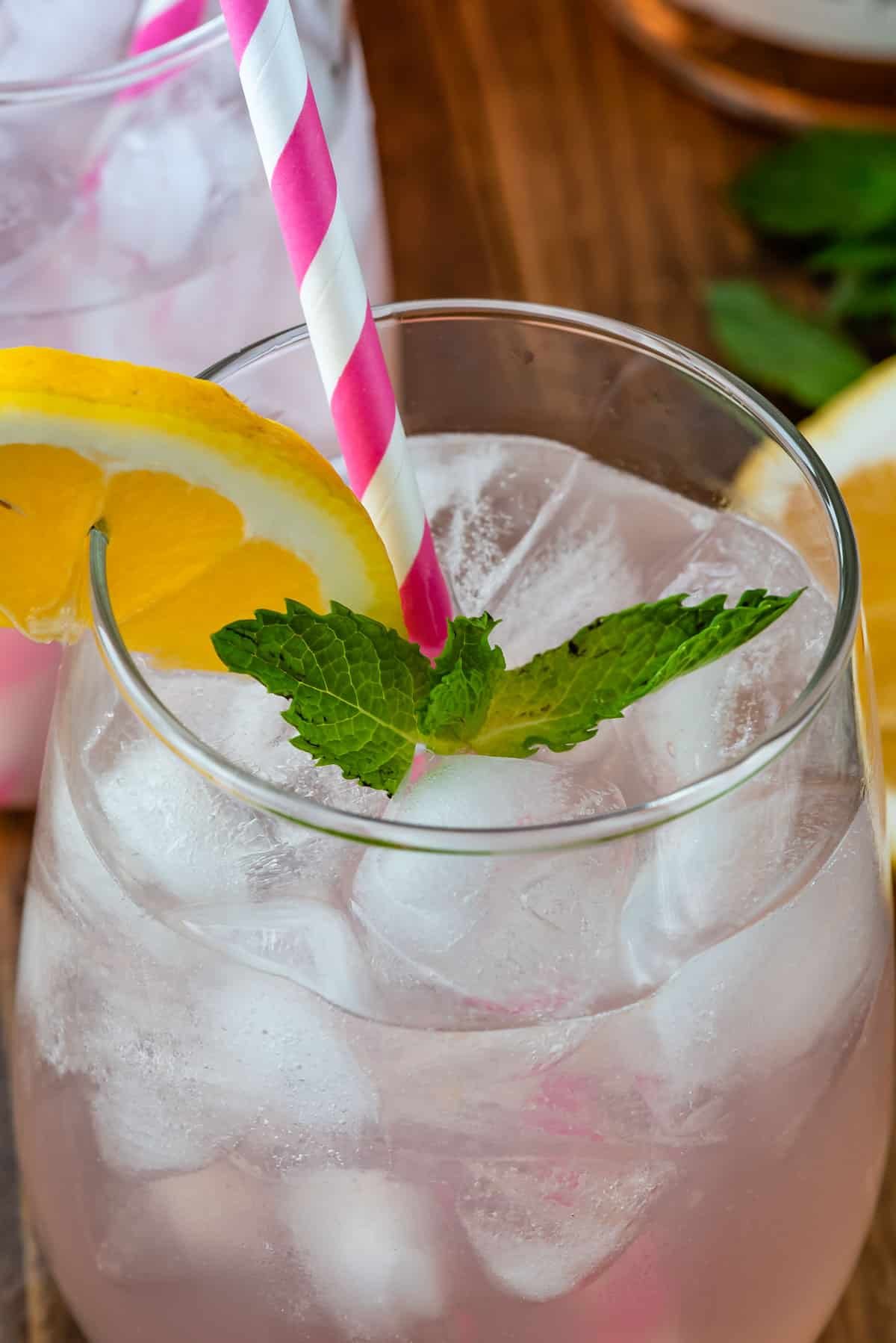 rose in clear glass with a lemon slice on the rim.