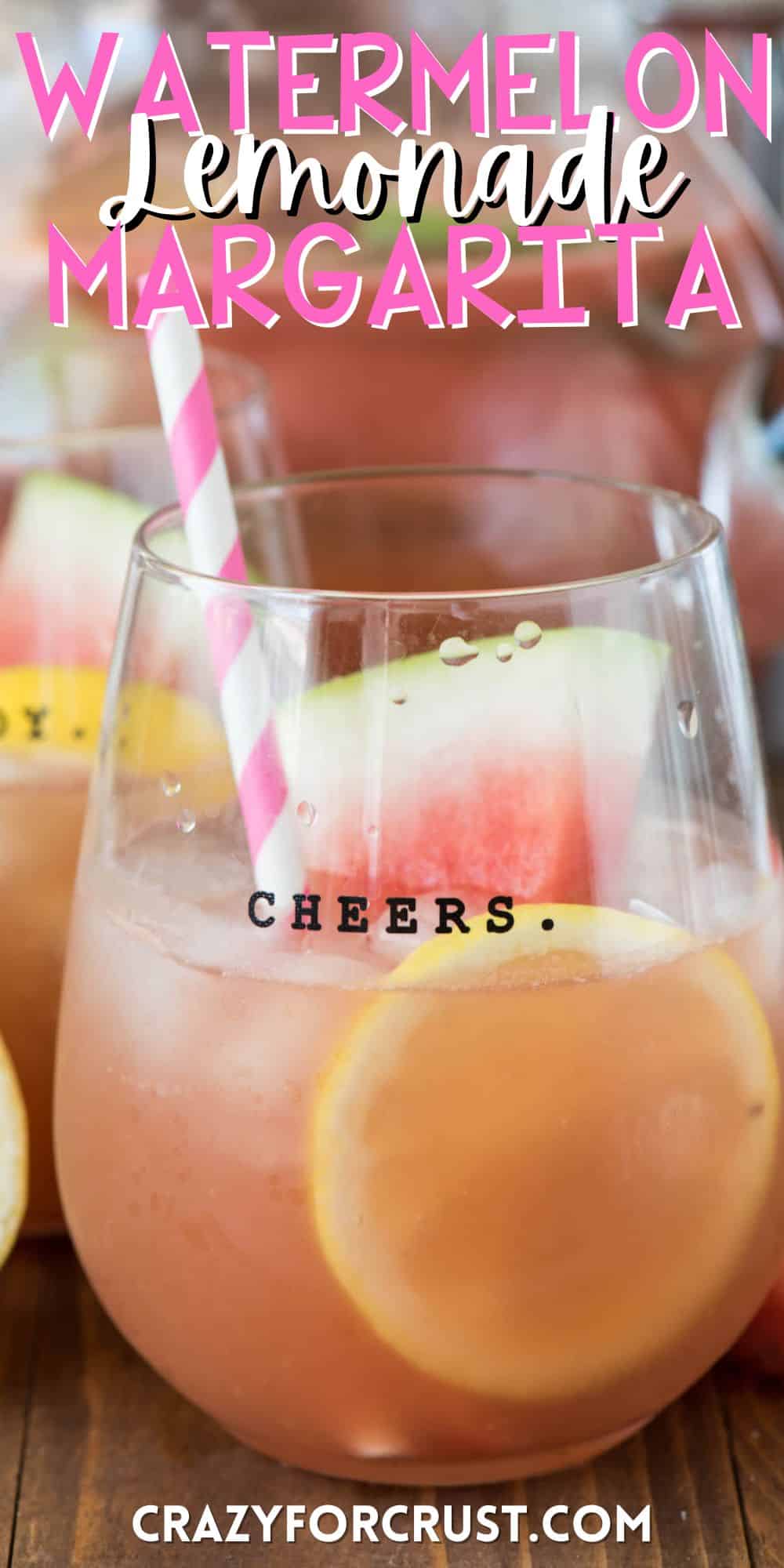 margarita in a short clear glass with sliced watermelons and lemons and a pink and white straw with words on the image.