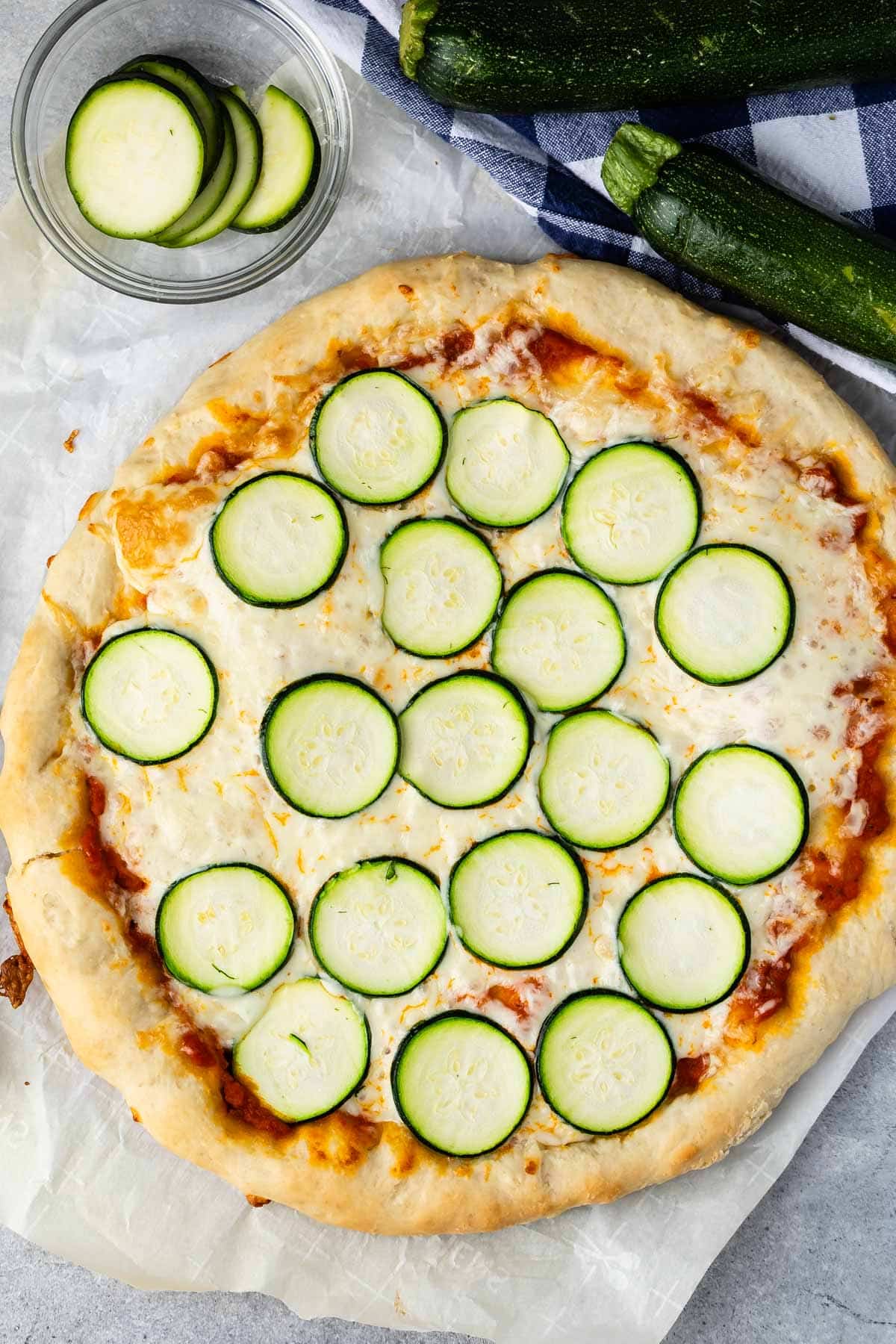 pizza with sliced zucchinis on top.