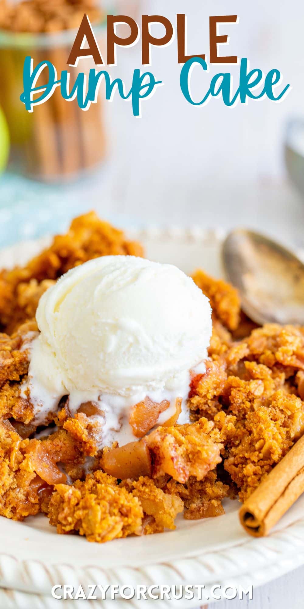 orange dump cake on a white plate with white ice cream on top with words on the image.