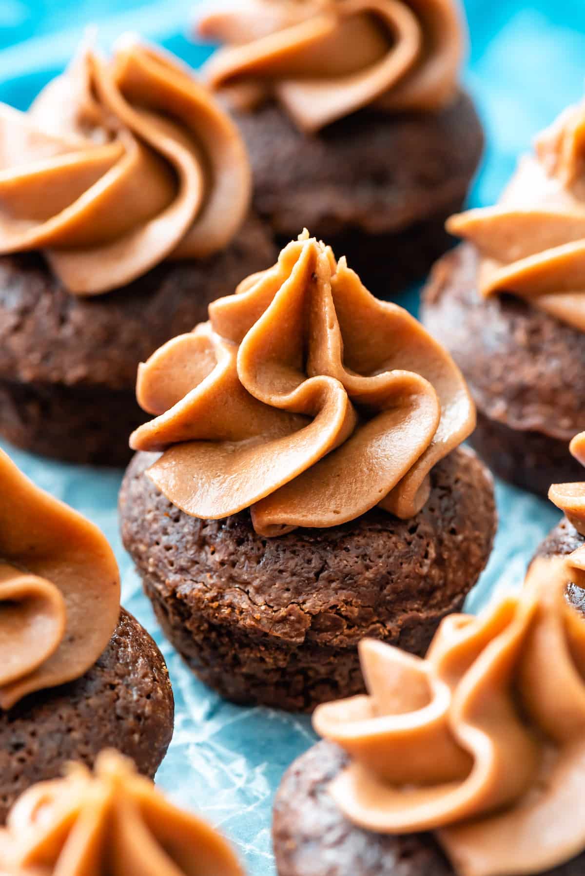 mini brownie bites with chocolate cream cheese frosting on top.