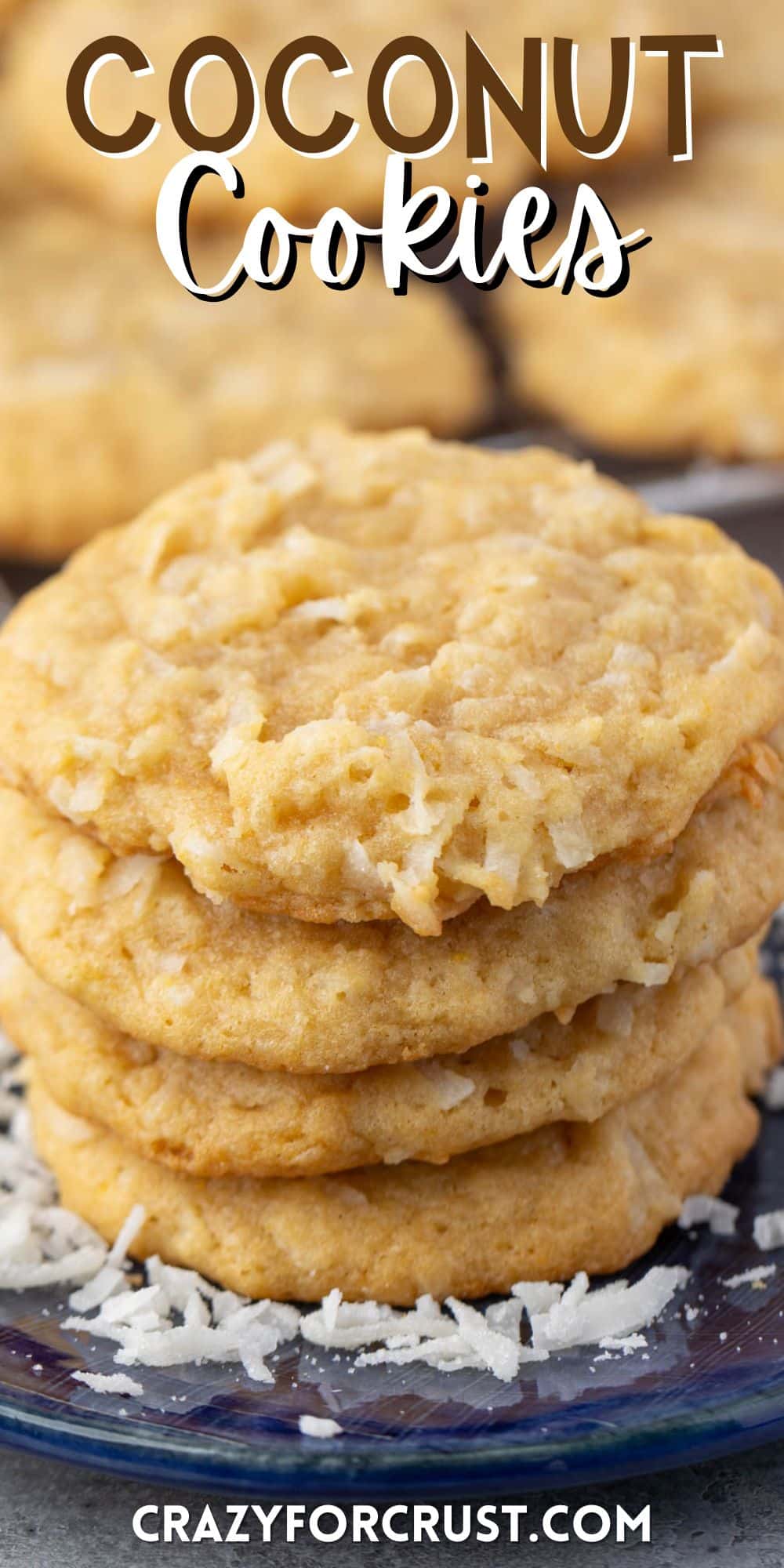 stacked coconut cookies on a navy blue plate with sprinkles coconut around the cookies with words on the image.