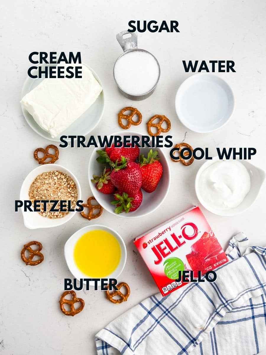 ingredients in pretzel salad on counter with blue striped napkin.