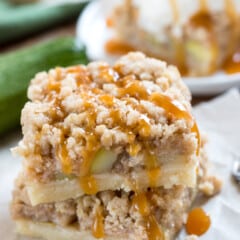 stacked zucchini bars with zucchini baked in and a crumble topping.