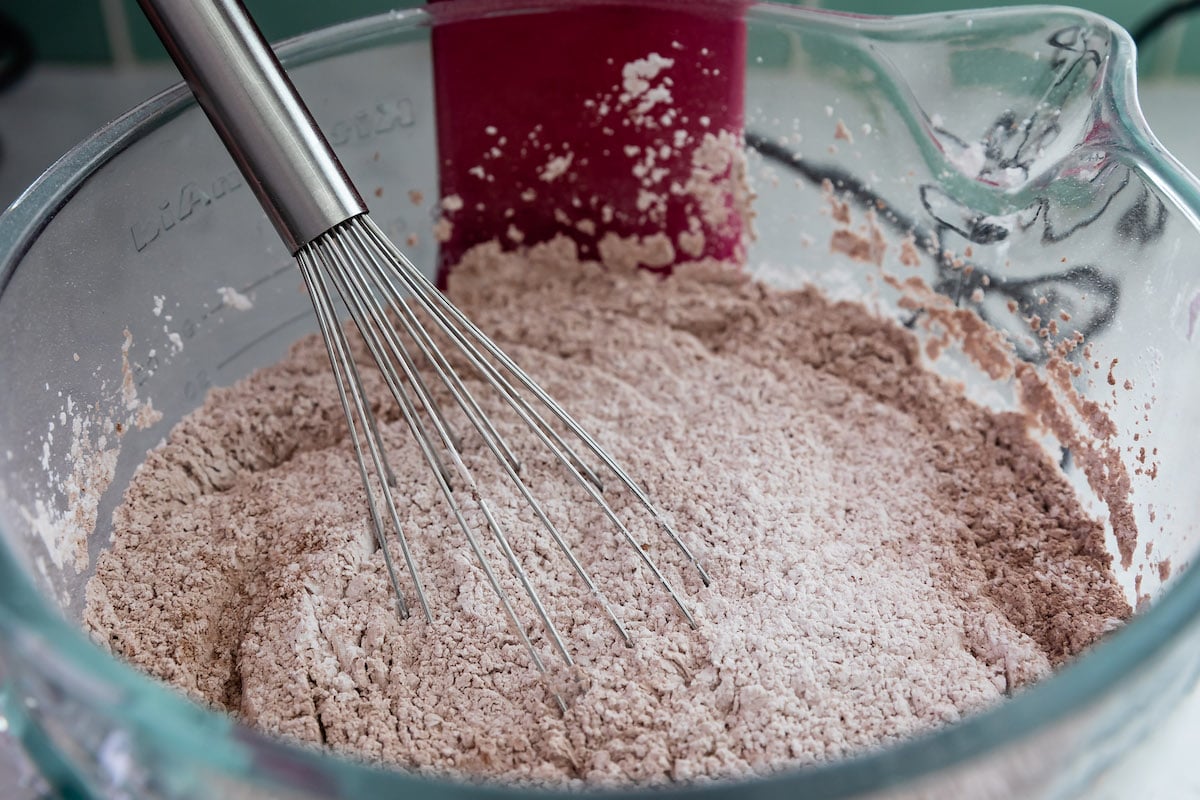 bowl of cocoa and powdered sugar with whisk.