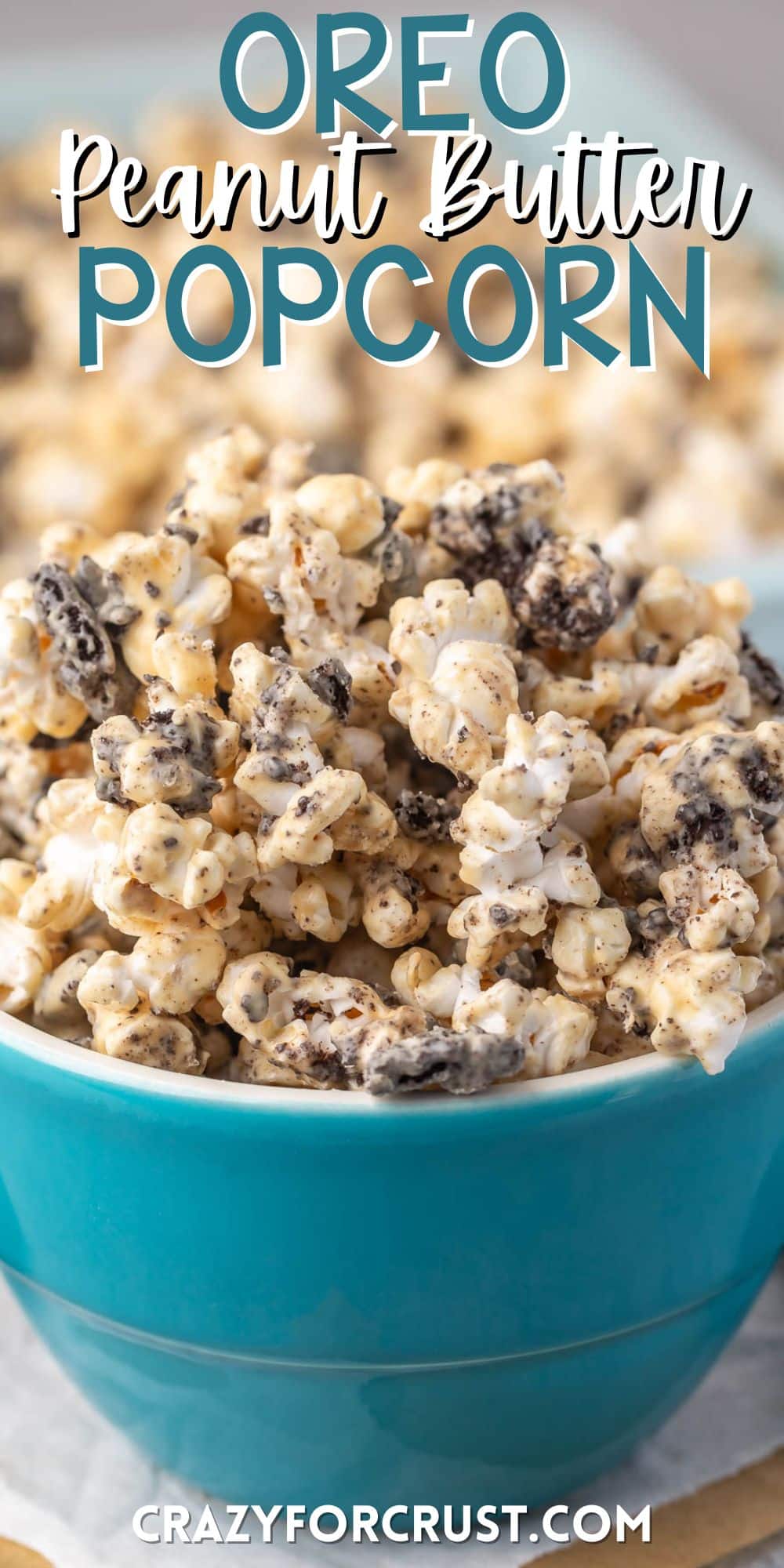 popcorn covered in melted chocolate and peanut butter in a teal bowl with words on the image.